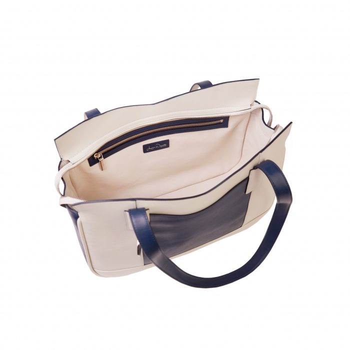 A white and blue bag is shown with its inside compartment open.
