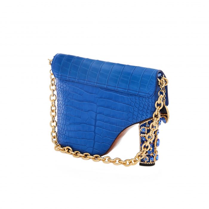 A blue purse with gold chain and leopard print handle.