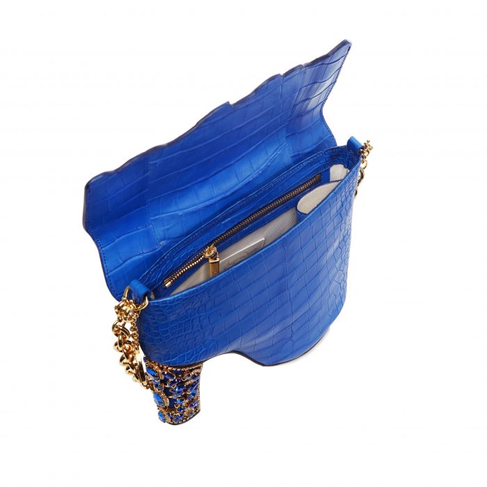 A blue purse with gold chain and an open pocket.