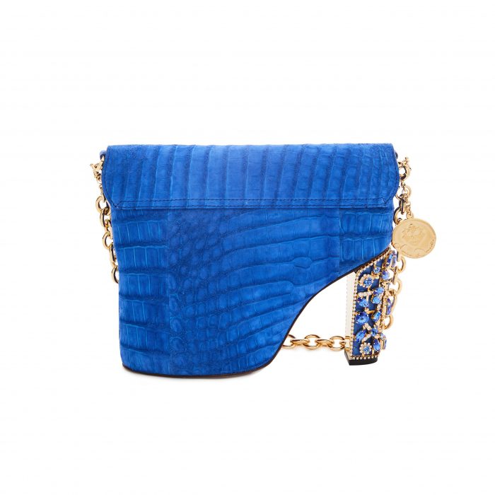 A blue purse with gold chain and a strap.