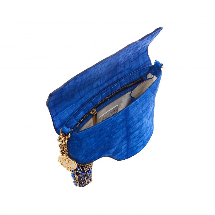 A blue purse with a key on the side of it.