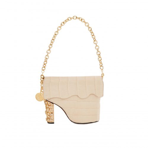 A white purse with a gold chain and heel.