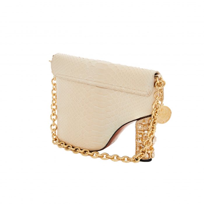 A white purse with gold chain and a gold clasp.