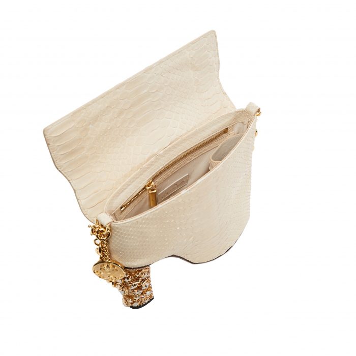 A white purse with gold chain handles and a wooden handle.