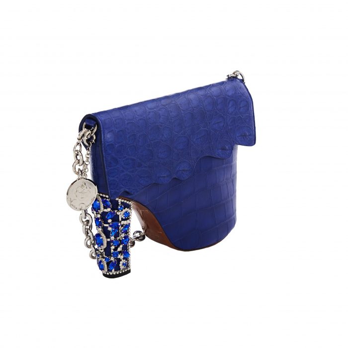 A blue purse with a chain strap and a coin holder.