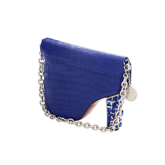 A blue purse with chain strap and silver chain.