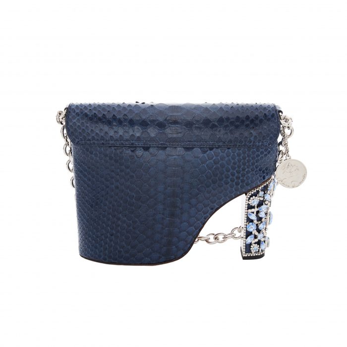A blue purse with a chain handle and a coin on the strap.
