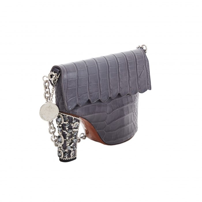 A gray purse with a chain strap and a leopard print handle.