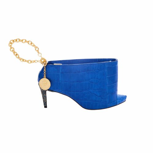 A blue shoe with gold chain and a coin on it.