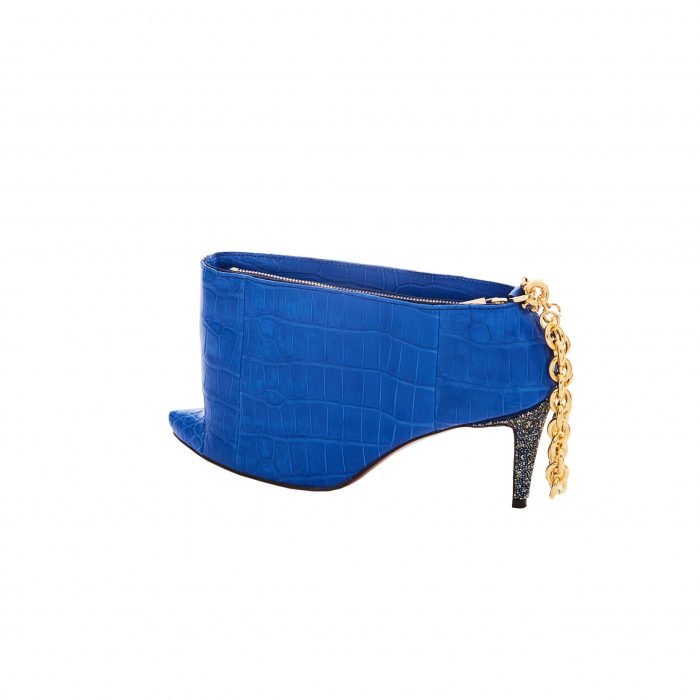 A blue shoe with gold chain on the side.