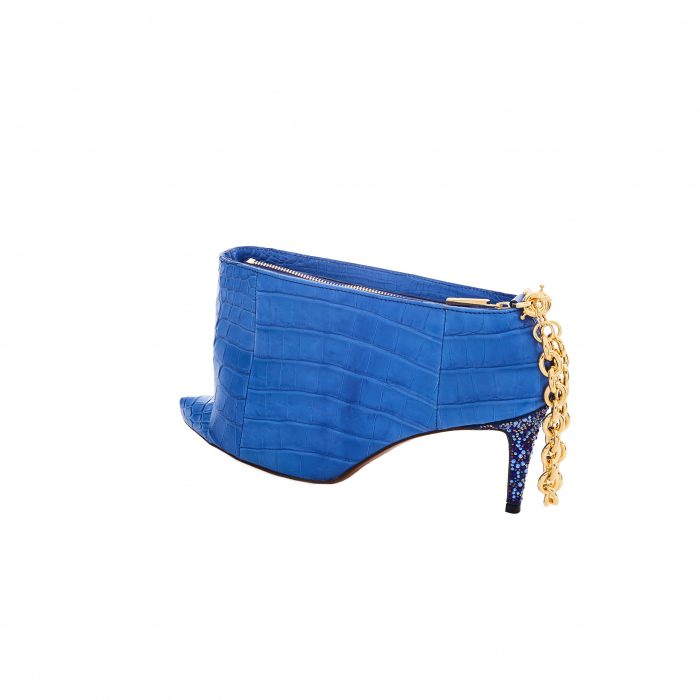 A blue shoe with gold chain on the side.