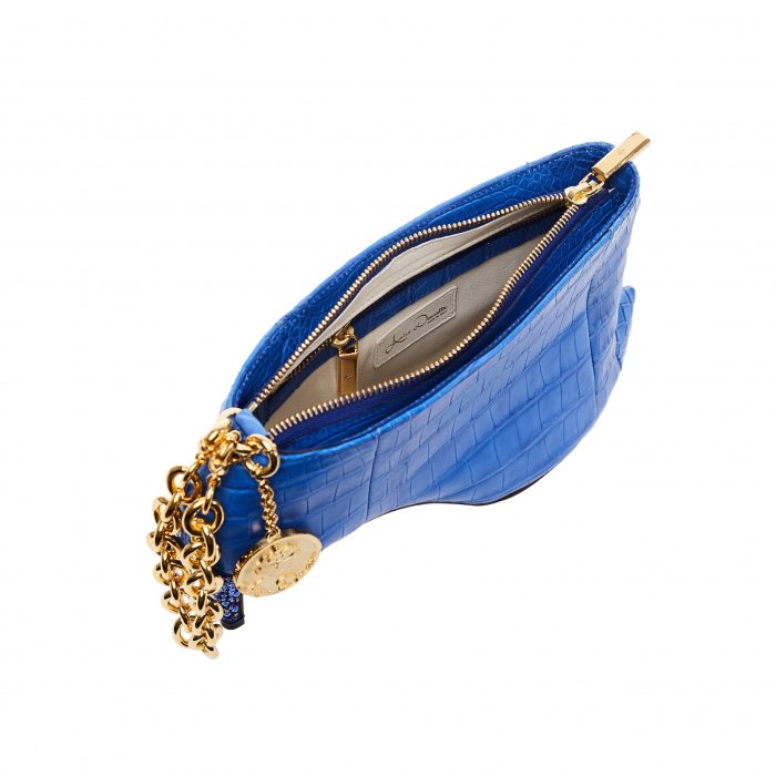A blue purse with gold chain and a coin holder.