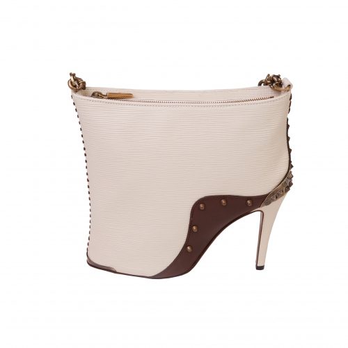 A white purse with brown heels on it