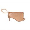 A tan purse with a gold chain hanging off of it.