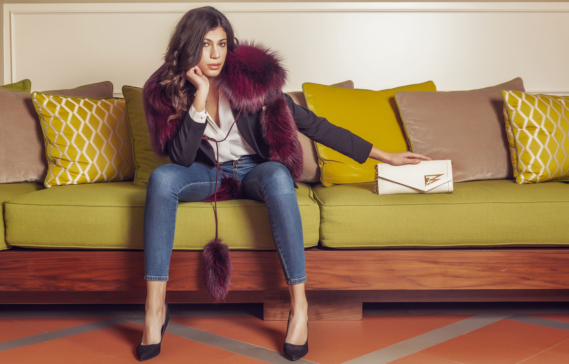 A woman sitting on the couch wearing high heels